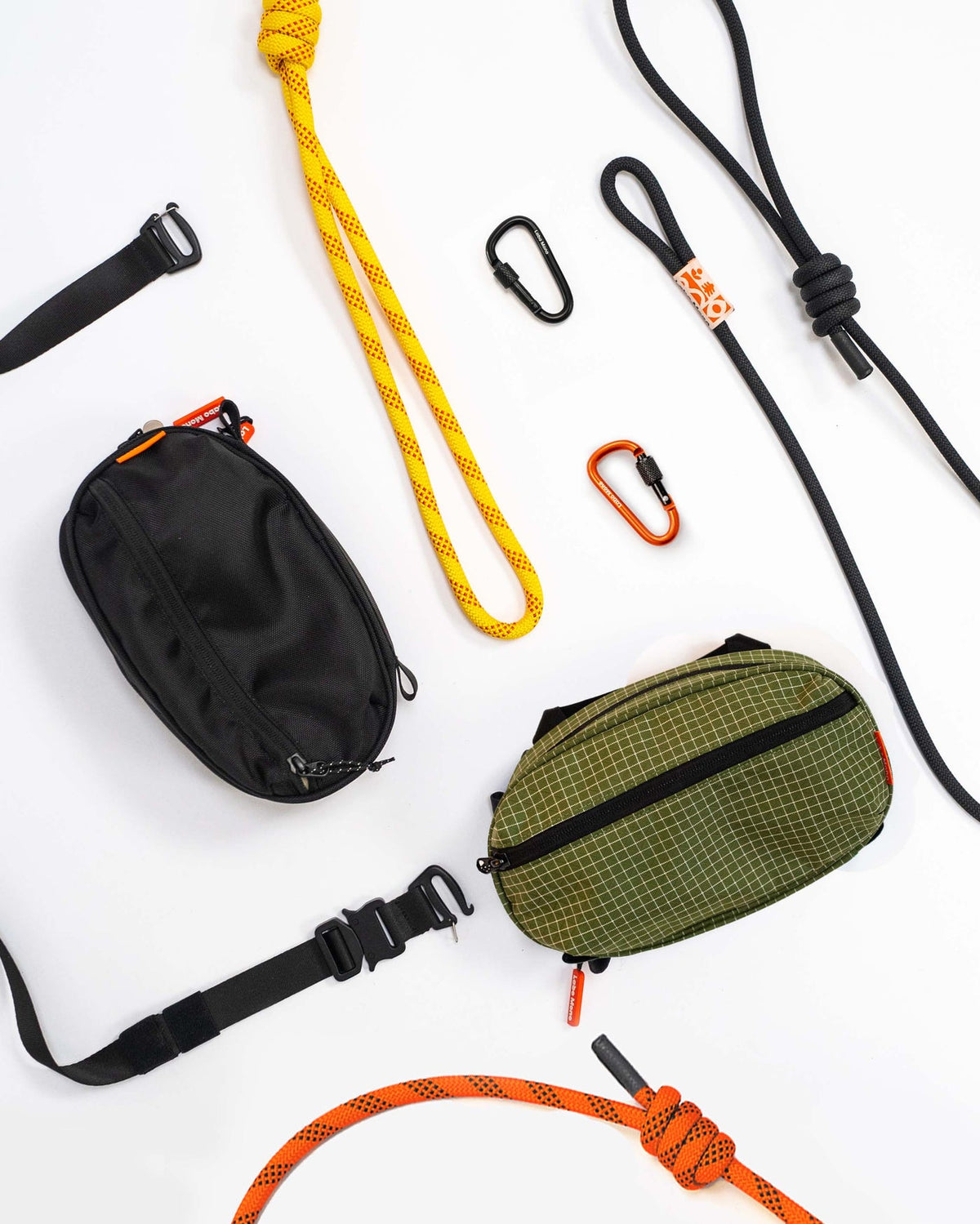 Sling bags, rope straps, flat straps and carabiners laid out as parts