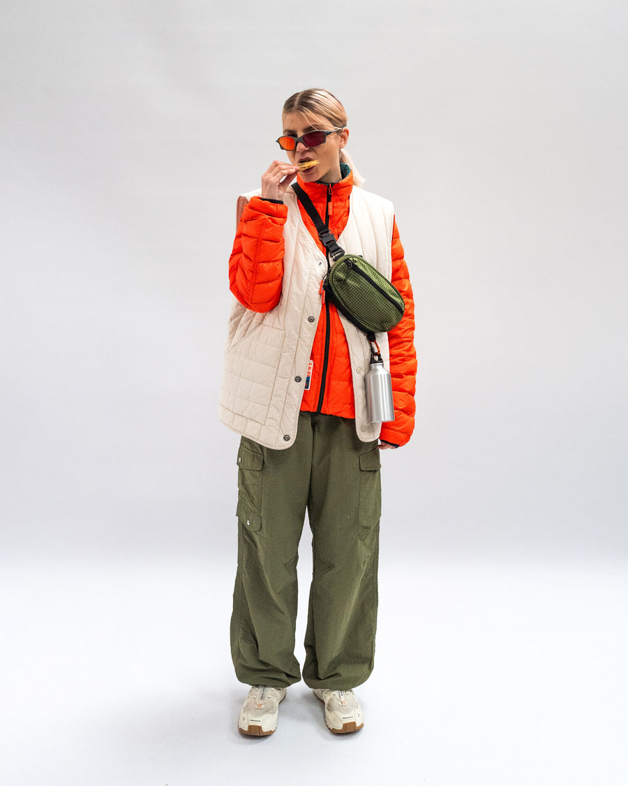 Sling Bag - Medium in Olive with a flat strap, worn across the body.