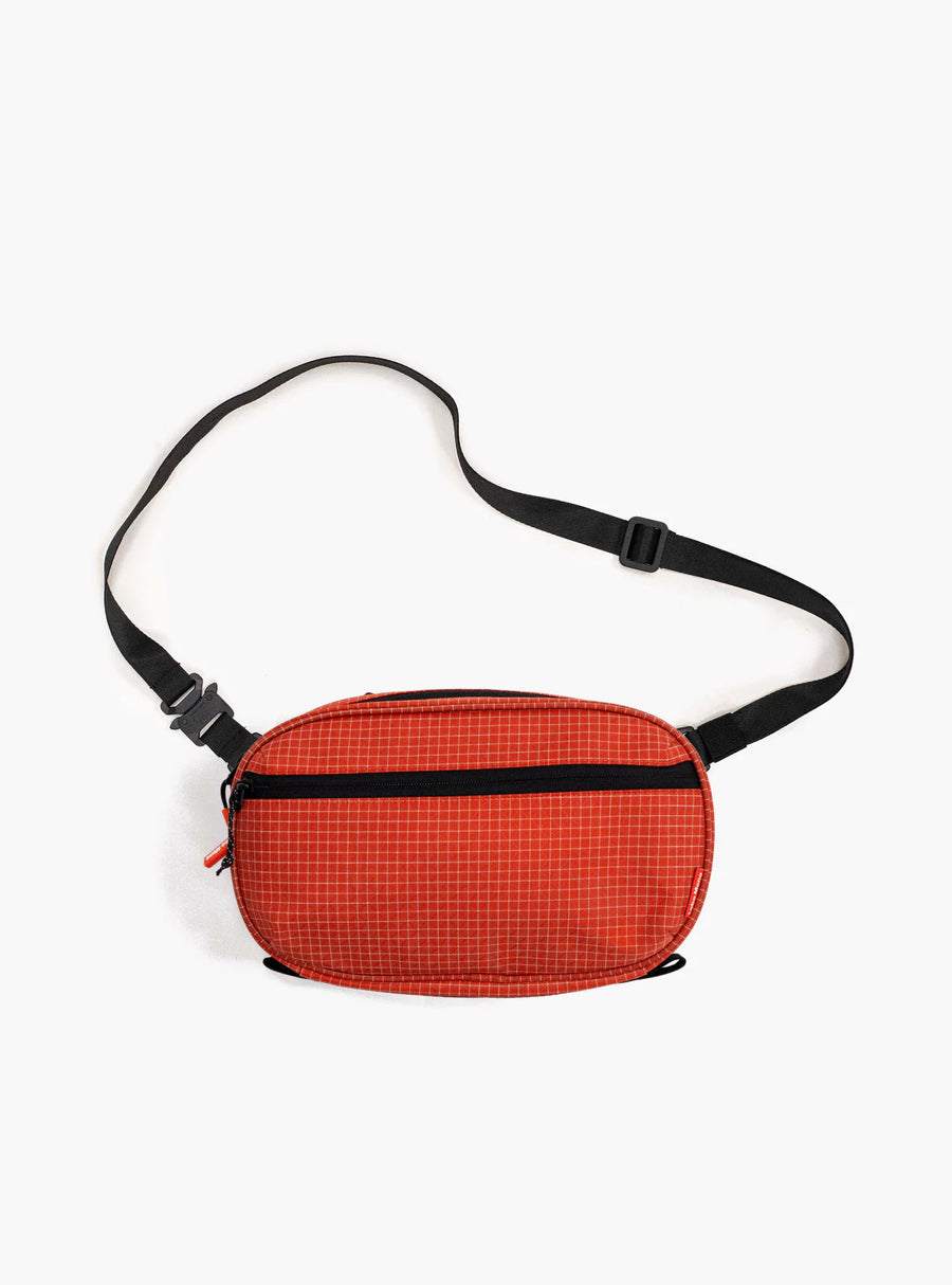 Sling Bag - Large in Chili with a flat strap.