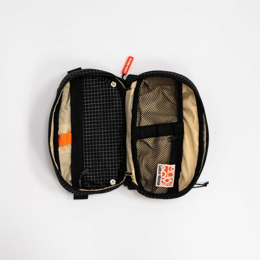 Sling Bag - Medium in Black, fully opened to show its compartments.