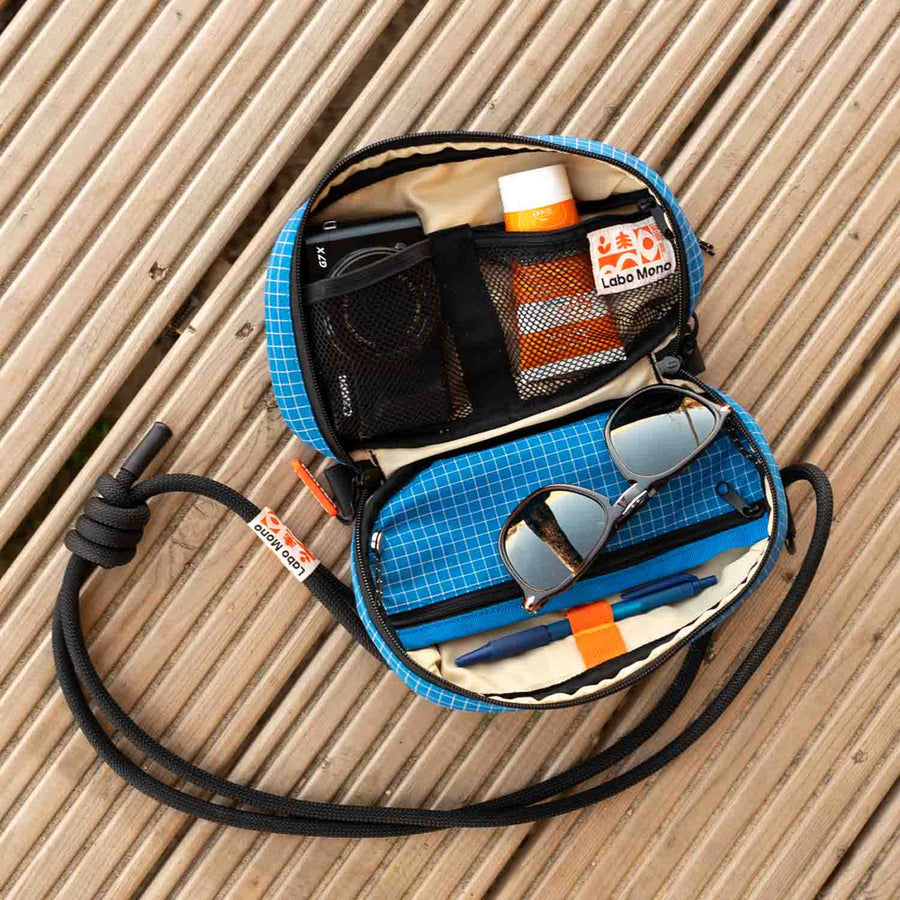 The sling bag opened fully flat with its contents in view